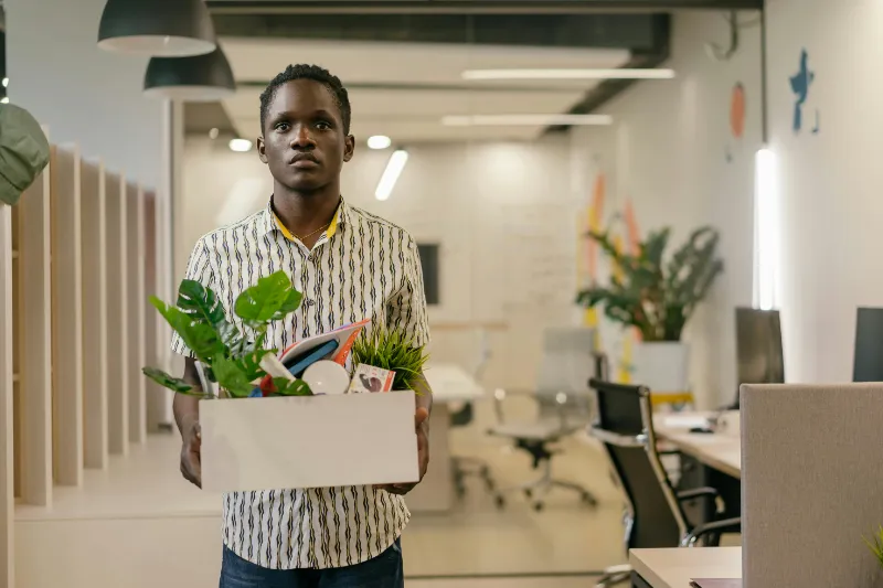 Adult holding a box during a life transition, symbolizing therapy during change