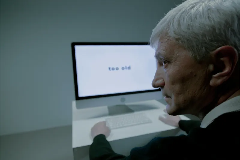 Older adult using a computer during a telehealth therapy session