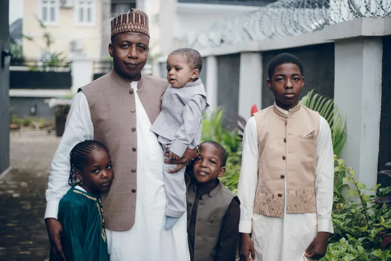 family portrait in traditional attire outdoors